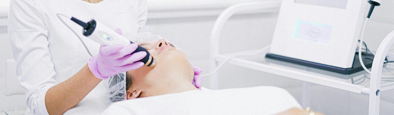 A woman receives laser skin tightening at DSL Clinic for radiant, youthful skin.